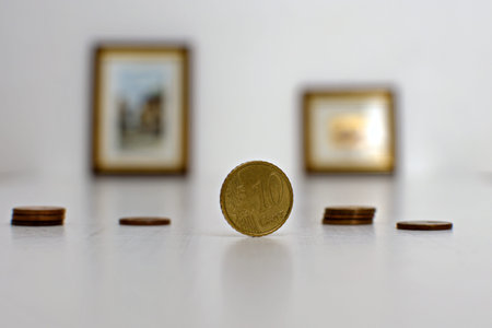 10 cents coin close up on blurred background with photo in frames