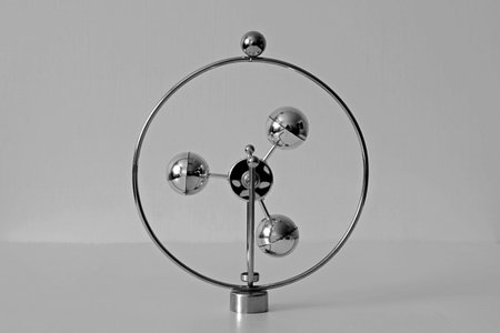 three balls of metal pendulum on a blurred painted background