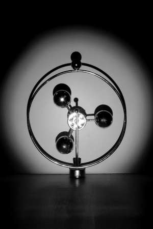 abstract metal construction with shiny balls in spotlight beam on white backgroundの写真素材