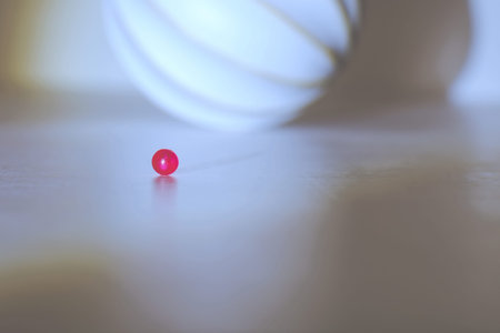 small red ball on blurred background with shadows
