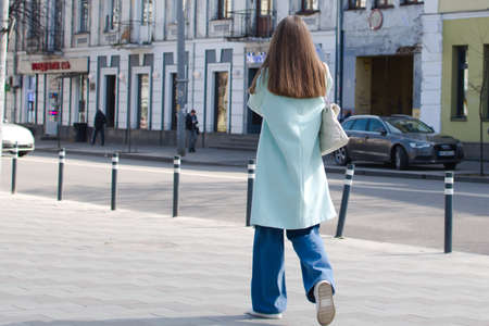 Ukraine Zhytomyr March 30, 2021. Girl with long blond hair on blurred background of old cityのeditorial素材