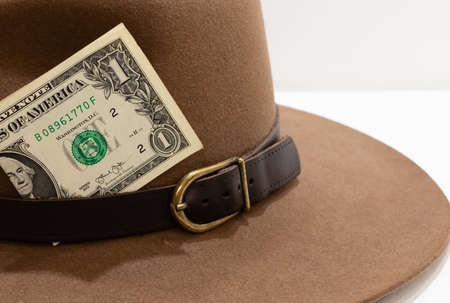 One american dollar banknote in felt hat on blurred backgroundの写真素材