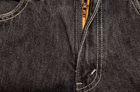 Zipper on black denim trousers with double stitching close-up. Front viewの写真素材