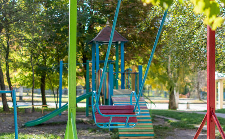 Bright multi-colored playground in courtyard of multi-storey buildings in residential areaの写真素材