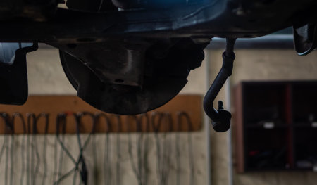 Repair of undercarriage of front suspension of vehicle in garage of car serviceの写真素材