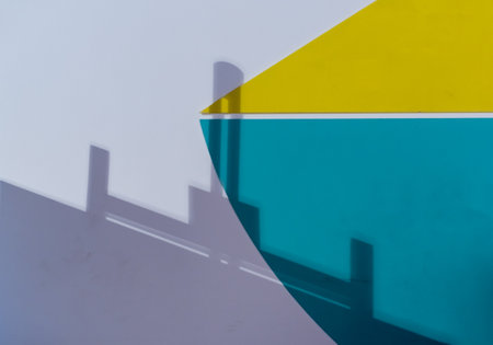 Blurred shadow of geometric figures on colorful wallの写真素材