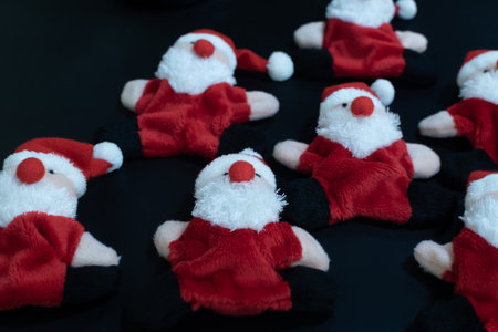 Funny Santa Claus toys lying on black table backgroundの写真素材