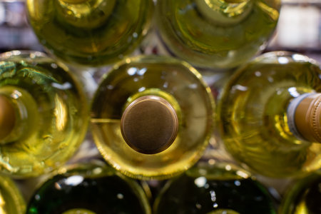 Stack of white wine bottles in horizontal position close-up