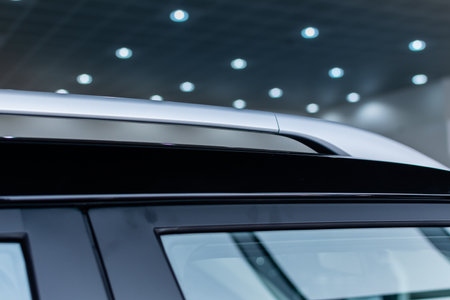 Silver roof rails close-up on roof of modern car on blurred background of light illuminationの写真素材
