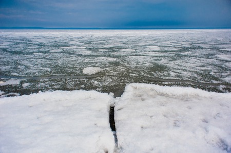 Day at Baikal Lake. Spring floating of ice .の写真素材