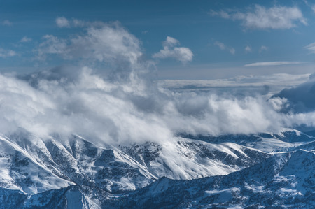 Snowy winter mountains in sun day. Caucasus Mountains, Georgia, from ski resort Gudauriの写真素材