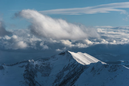 Snowy winter mountains in sun day. Caucasus Mountains, Georgia, from ski resort Gudauri