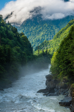 Mountain slopes landscape with fir trees in the fog in Svaneti, Georgia.の写真素材