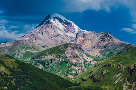 Mount Kazbek view from Stepantsminda town in Georgia in good weather for climbing. It is a dormant...