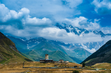 Village Ushguli landscape with massive rocky mountains Bezengi wall, Shkhara on the background in Svaneti, Georgiaの写真素材
