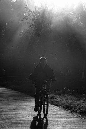 OBNINSK, RUSSIA - MAY 17, 2019: Silhouette of a man on a bicycle.のeditorial素材