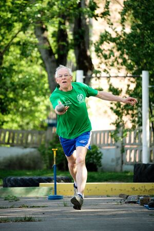 MOSCOW, RUSSIA - MAY 12, 2018: Russian athlete Mikhail Popov throws a metal ball for bocce volo on tournament Day Running.のeditorial素材