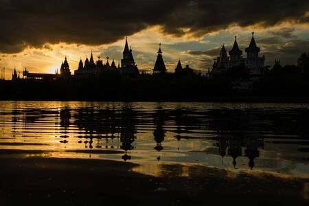 Beautiful view of the Kremlin Izmailovo through a silver-grape pond at sunset.の写真素材