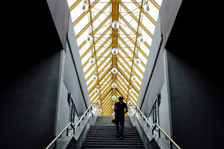 MOSCOW, RUSSIA - JULE 26, 2018: A man climbs the stairs inside the Andreevsky Bridge.