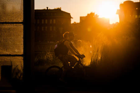 MOSCOW, RUSSIA - JUNE 25, 2016: A guy riding a bicycle at sunset in the Museon Art Park.のeditorial素材