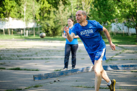 MOSCOW, RUSSIA - MAY 12, 2018: Russian athlete Yuri Duplyakin throws a metal ball for bocce volo on tournament Day Running.のeditorial素材