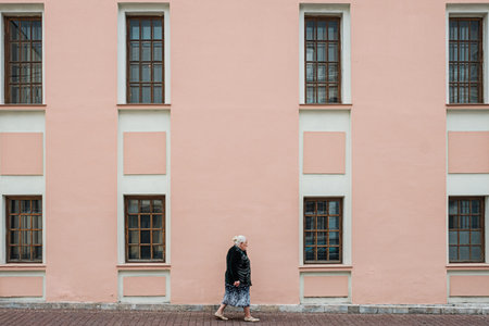 MOSCOW, RUSSIA - JULY 18, 2019: Grandmother walks along the Big Znamensky lane.