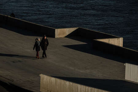 MOSCOW, RUSSIA - MARCH 15 2022: Boy and girl strolling along the Moskva river embankmentのeditorial素材