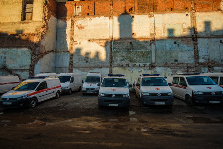 MOSCOW, RUSSIA - MARCH 15 2022: Ambulances stand in the background of an old house and the shadow of a church on itのeditorial素材