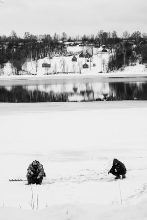 PLES, RUSSIA - JANUARY 3 2023: Men fishing on the banks of the Volgaの写真素材