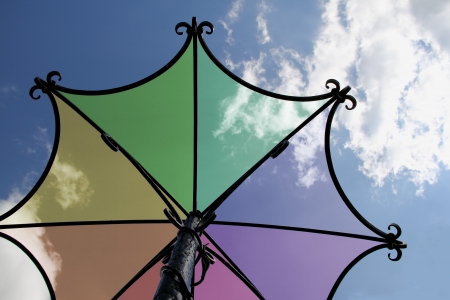 Metal sculpture umbrella against the sky with clouds の写真素材