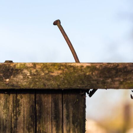 One old nail sticks out of the fence.の写真素材