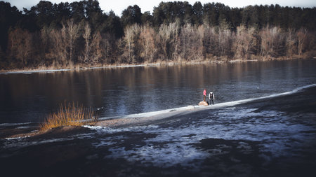 Two are walking by the river.Landscape