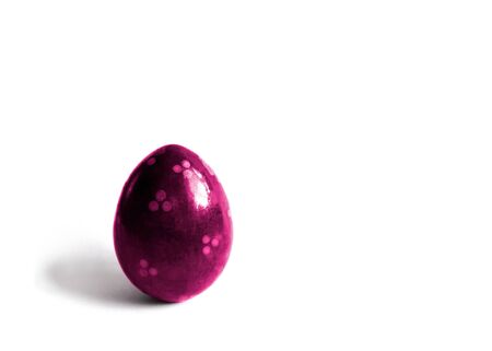 One pink easter egg with shadow on a white background.の写真素材