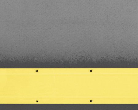 Yellow wide metal stripe on a gray background. Located at the bottom of the photo. with place for text.の写真素材