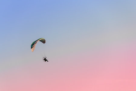 One paraglider flies in the sky at sunset. Space for text.の写真素材