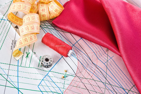 Pattern, yarn and needles with a piece of satin material