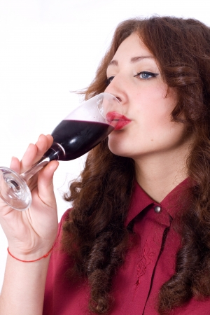 Closeup of beautiful female lips drinking wine from a glass with dewdrops on itの写真素材