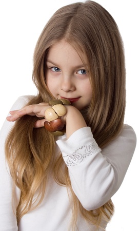 little girl with a wooden bracelet poses for the cameraの写真素材
