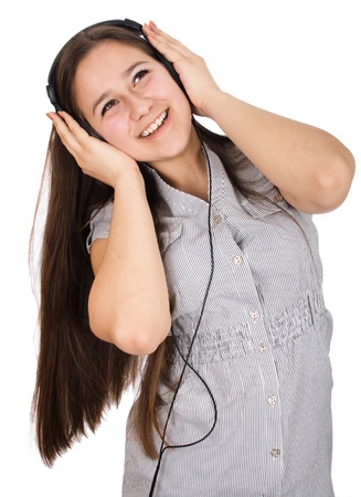 young girl happily listening to music on headphonesの写真素材