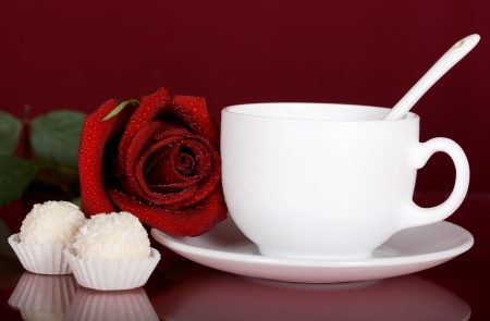 Romantic surprise in the form of a red rose, tea and chocolatesの写真素材