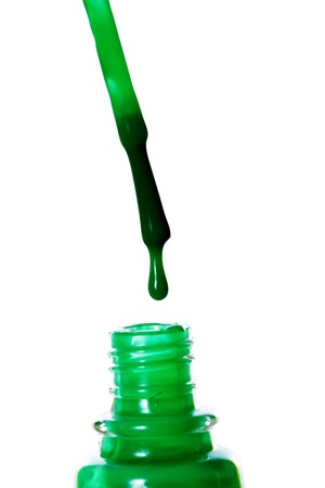 Nail polish dripping from brush macro. Isolated on white background.の写真素材