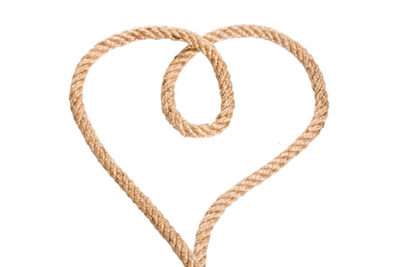 Rope heart shaped symbol, isolated on a white background.の写真素材