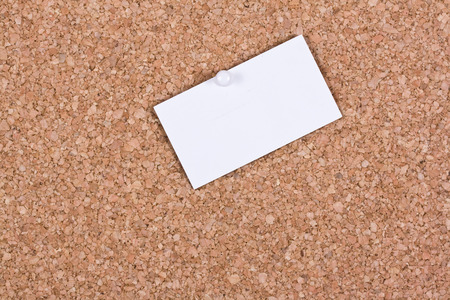 White blank business card attached to a cork boardの写真素材