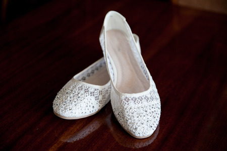 Summer ballet flats of white color against a dark backgroundの写真素材