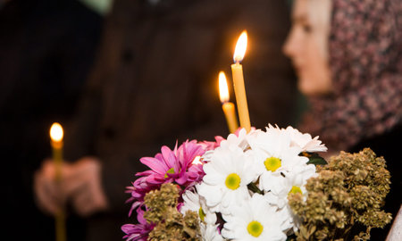 Typical votive candle in the darkness of a church, light up for a prayer.