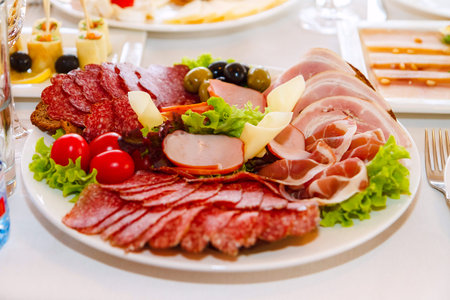 Meat sausage slices assortment on Party Plate, top view
