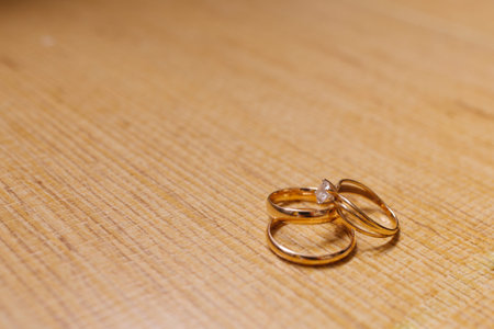 Two wedding rings on a yellow background