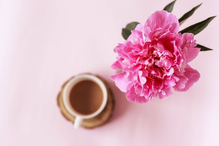 Banner of Bouquet Peony flowers on pink backgroun and cup of coffee. Copy space. flat lay. Good morningの写真素材