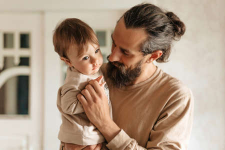 Father with a small son in his arms playing and talkingの写真素材