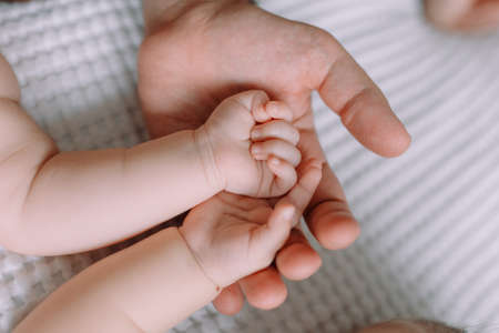 Love and family concept, baby hand on mother`s hands.の写真素材